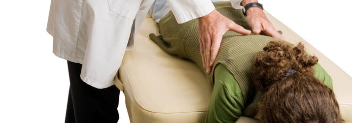 Chiropractor Adjusting A Patient